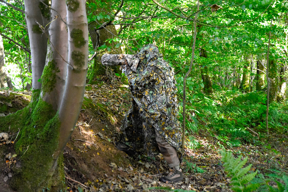 Leafy Poncho, super lightweight & compact. 1.7mt wide 2.2mt long with hood and face veil. Can also be used as a camouflage cover or screen. Made from 3D leafy material on a tough fine mesh base. An excellent quick use lightweight camouflage Lightweight - Compact - Multi use - Quick drying Camouflage Poncho/Cover/Screen. The photo also shows our C80R Camera cover and B29.5 Leafy gloves.